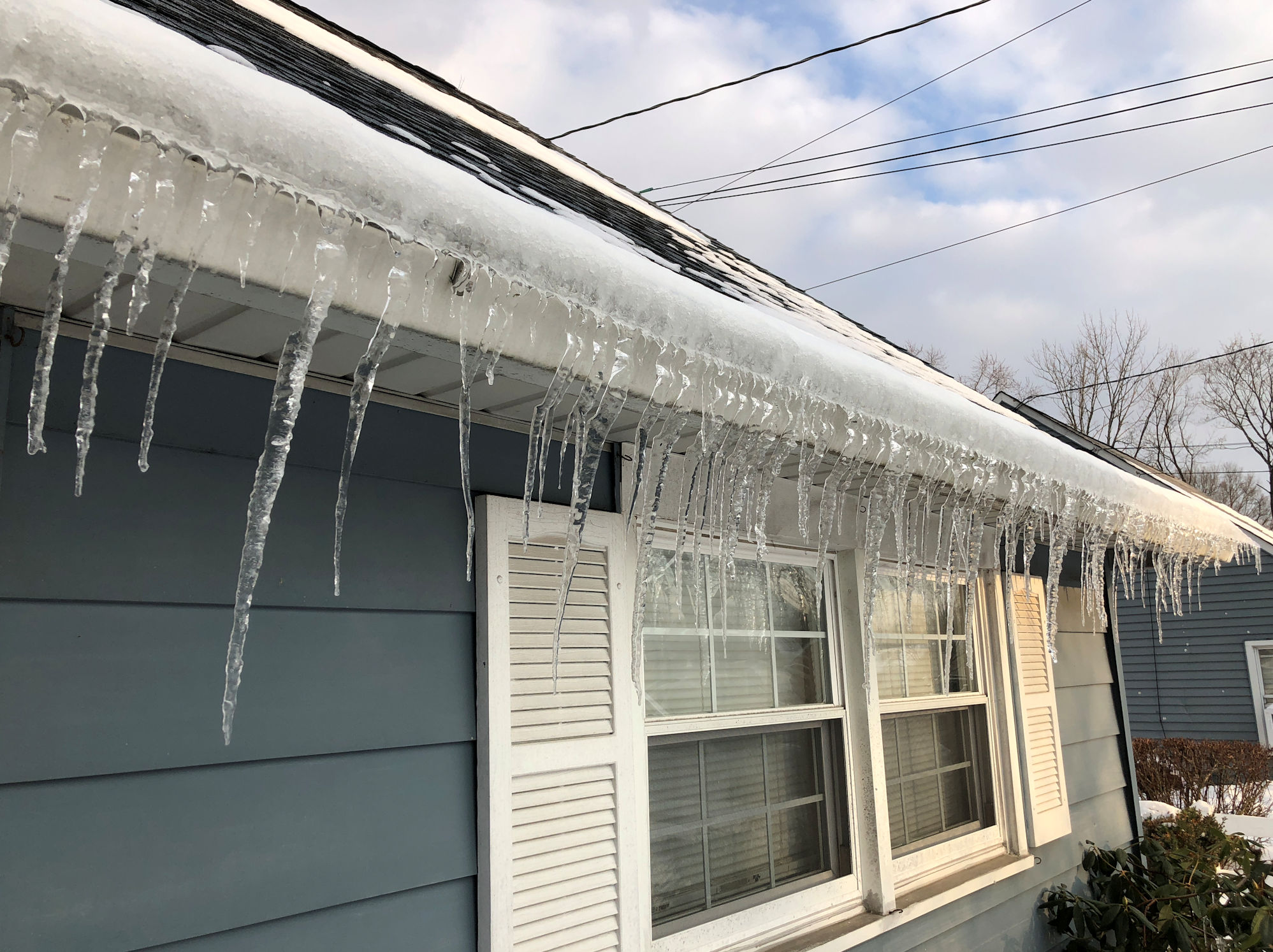 ice dam created by clogged rain gutter