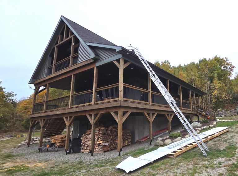 Rain gutters being installed on a chalet