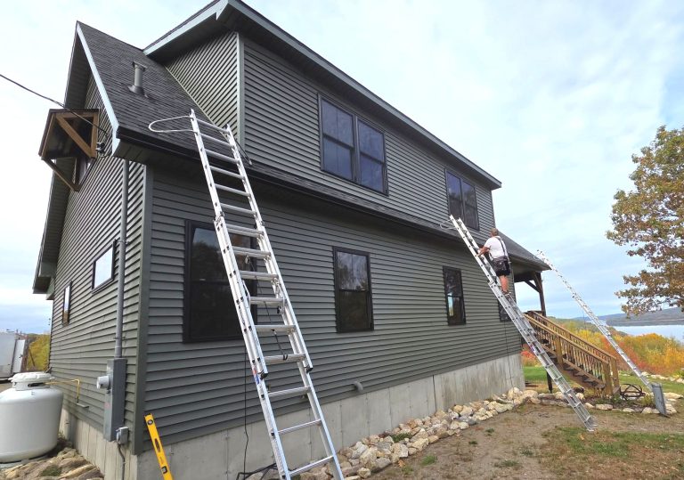 seamless gutters being installed on Maine coast house