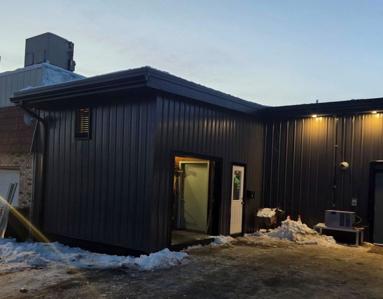 black rain gutter matches steel building colors