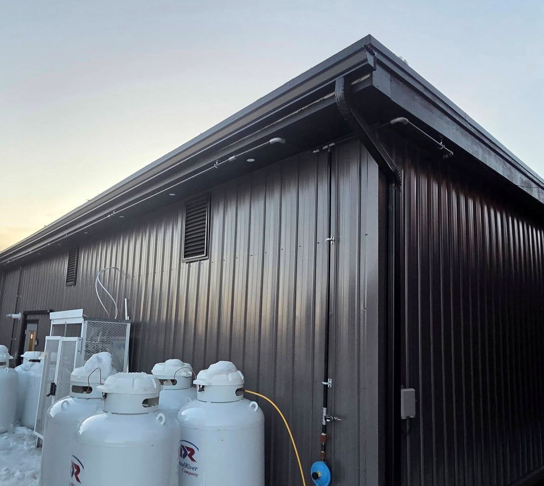 black rain gutter matches steel building colors