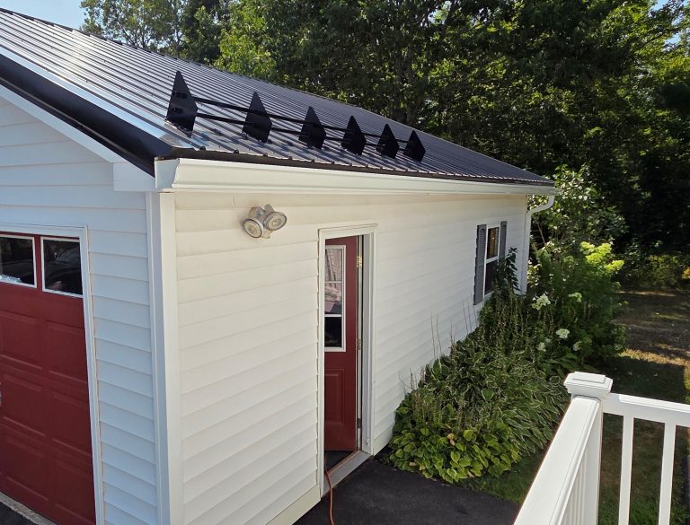 new rain gutter matches the new siding on a garage