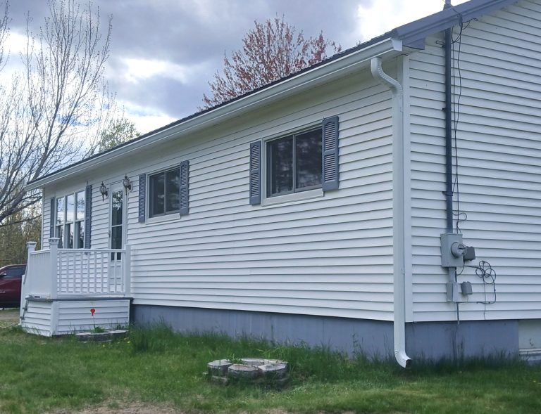 white rain gutters matching house trim and protect entry porch