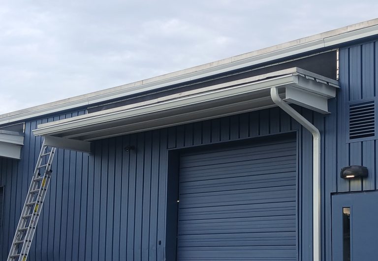 rain gutter protects the overhead door on a commercial building
