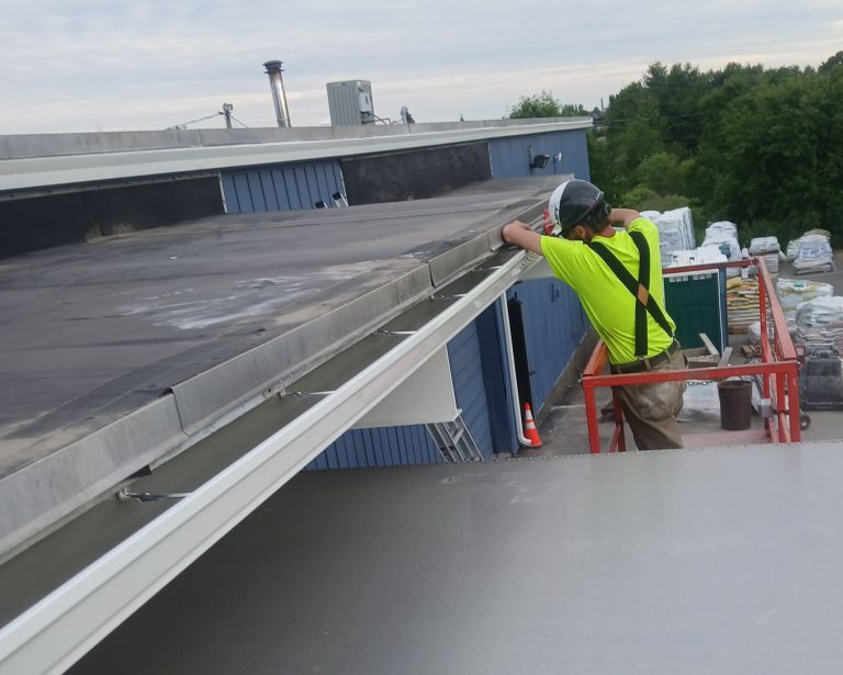 rain gutter being installed on commercial building